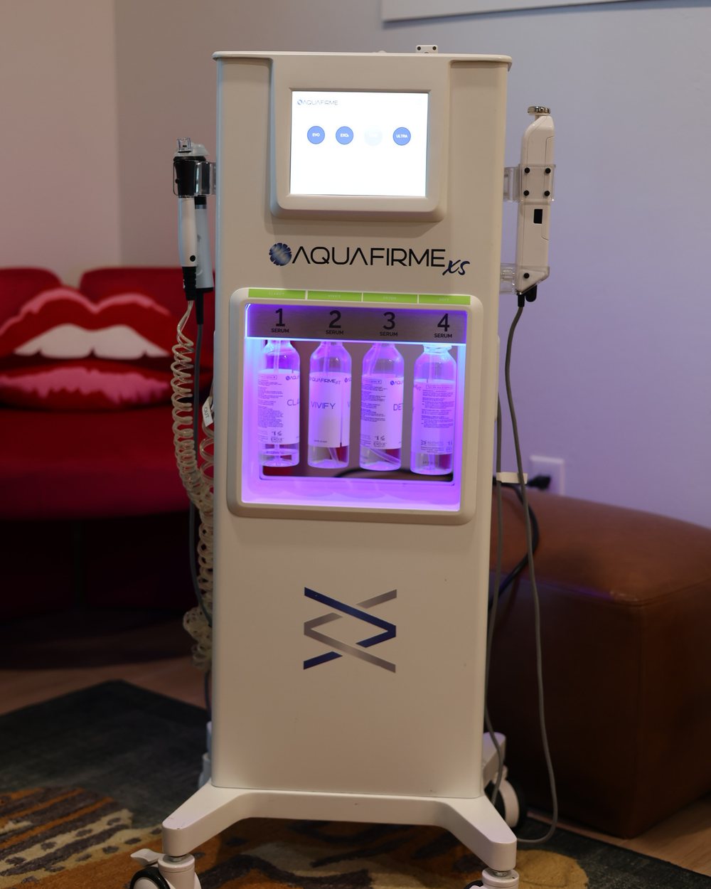 The AquaFirme XS system, its serum bay lit, in a Gudgel Aesthetics treatment room